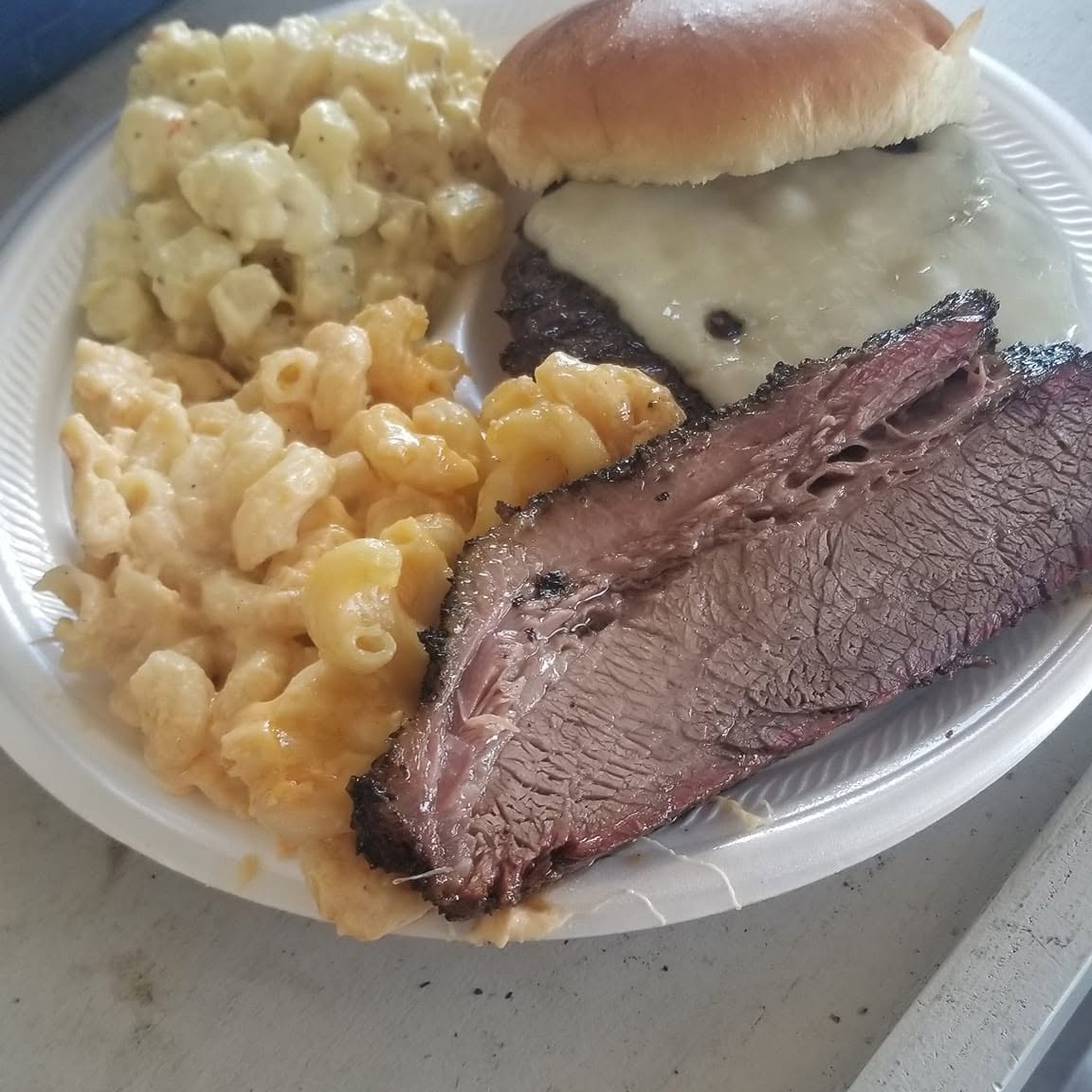 BBQ plate with brisket, macaroni and cheese, slaw, and a bun