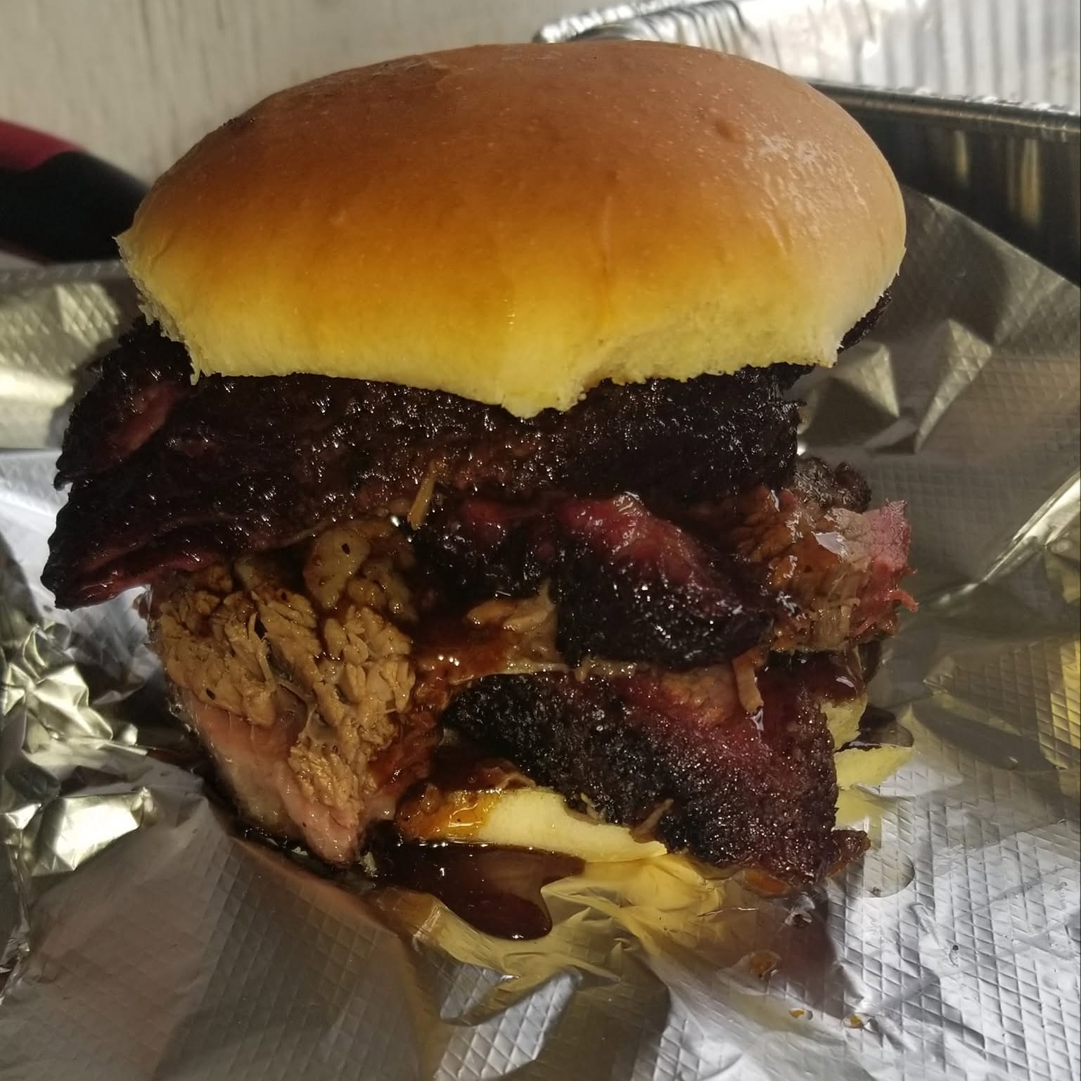 Chasin Tailz brisket sandwich on a soft bun
