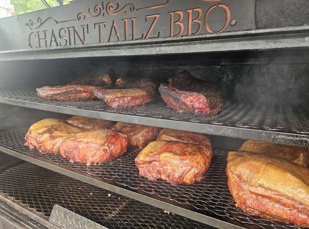 Ribs and meats smoking inside the Chasin Tailz pit