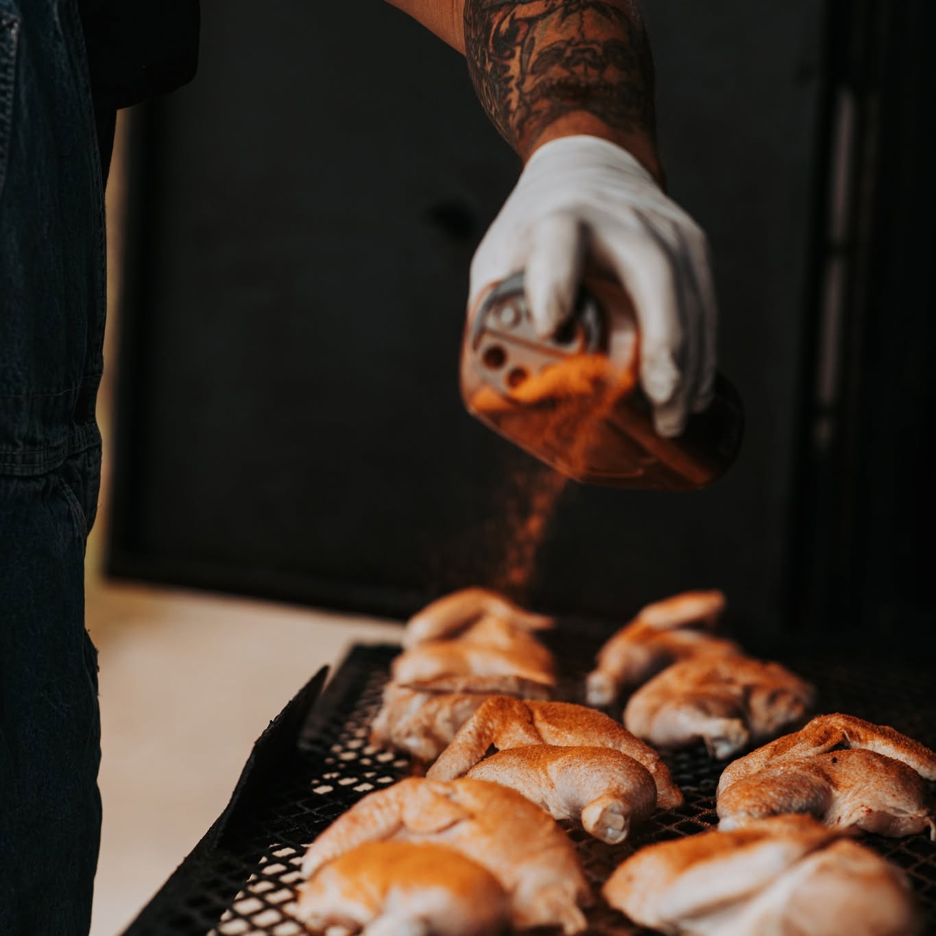 Bernie Thomas glazing smoked chicken for Chasin Tailz BBQ